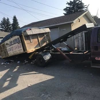 Bin trailer loaded for pickup in a Calgary back alley